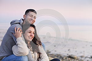 Young couple in love at rocky seacoast