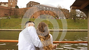 Young couple in love on sail boat, Happy lifestyle concept . Beautiful girl in white talking to a guy smiles.  Loving couple