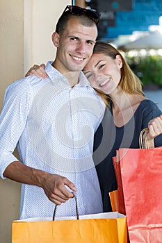 Young couple in love after shopping with shopping bags