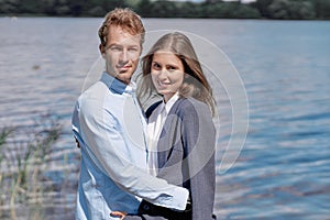 young couple in love standing together on the shore .