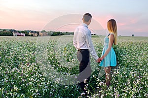 Young couple in love in summer field