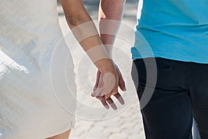 Young couple in love walking in the autumn park holding hands