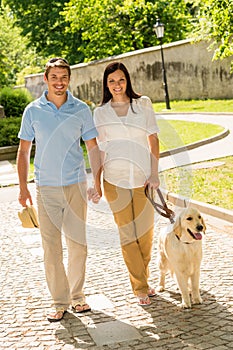 Young couple in love walking dog park