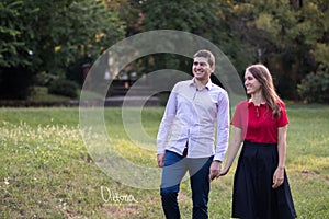 Young couple in love walking in the park, holding hands