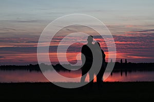 Young couple in love watching the sunset together