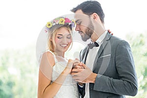 young couple in love Wedding Bride and groom holding hand together and looking at each other kissing in the park. Newlyweds.