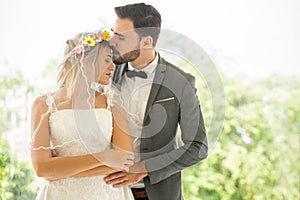 young couple in love Wedding Bride and groom kissing in the park. Newlyweds. Closeup portrait of a beautiful having a romantic