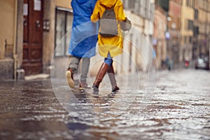 A young couple in love who is walking the city on a rainy day. Walk, rain, city, relationship