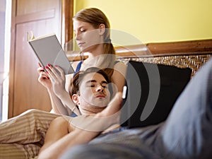 Young couple lying on bed