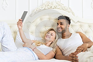 Young Couple Lying Bed Take Selfie Photo, Happy Smile Hispanic Man And Woman