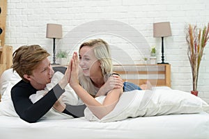 Young couple lying in bed together.