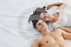 Young couple lying on bed together