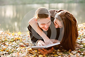 Young couple lying down reading