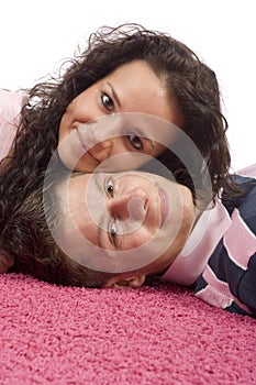 Young couple lying on the pink carpet