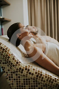 Young couple lying on the tepidarium beds