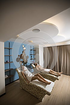 Young couple lying on the tepidarium beds