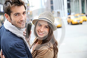 Young couple in mahattan with smartphone