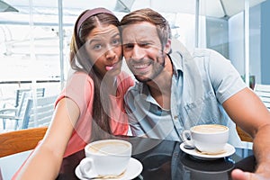 Young couple making selfie with weird faces