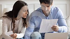 Young couple mange household finances at home