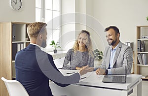 Young couple meeting with loan broker, bank manager, realtor or mortgage advisor