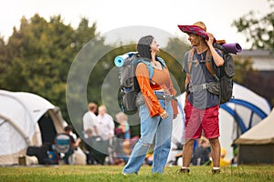 Young Couple Meeting At Summer Music Festival With Camping Equipment