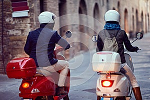 Young couple on motor scooter. Bikers on the road