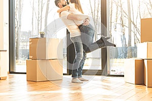 Young couple moves to a new home. the family carries boxes of things after buying a home.