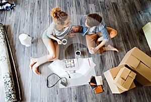 Young couple moving in new house, drinking coffee.