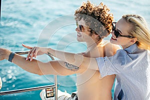 Young couple navigating on a yacht in caribbean sea