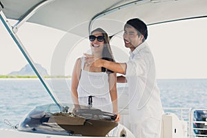 Young couple navigating on a yacht in Indian ocean.