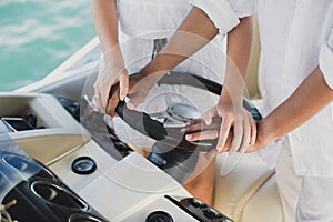 Young couple navigating on a yacht in Indian ocean.