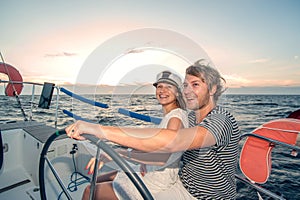 Young couple navigating on a yacht