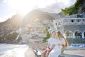 Young couple near beach in sunny day, Positano, Amalfi coast, Italy