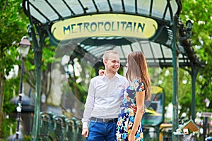 Young couple near the entrance of a metro station