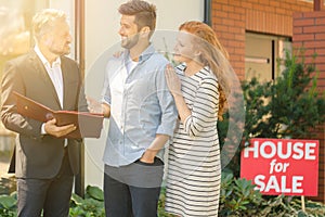 Young couple negotiating with agent