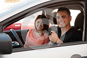 Young couple with a new car