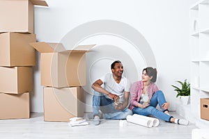 Young couple in a new house planning decoration moving home.