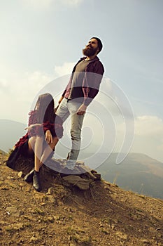 Young couple observe mountain scene