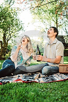 Young couple open champagne bottle