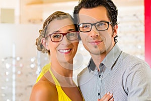 Young couple at optician with glasses