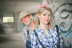 Young couple in overalls and helmets.