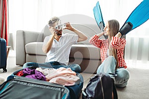 Young couple packing their baggage for vacation