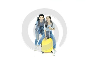 Young couple packing for vacation travel on isolated. Young Asian man and women are preparing for the journey happily on isolated