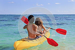 Young couple paddles their kayak photo