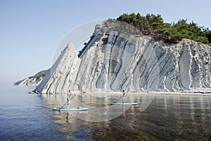 Young couple paddling on SUP board