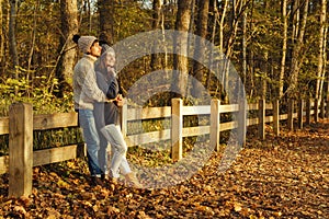 Young couple in the park at sunny autumn day