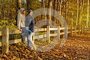 Young couple in the park at sunny autumn day