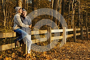 Young couple in the park at sunny autumn day