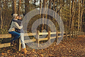 Young couple in the park at sunny autumn day