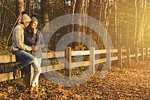 Young couple in the park at sunny autumn day